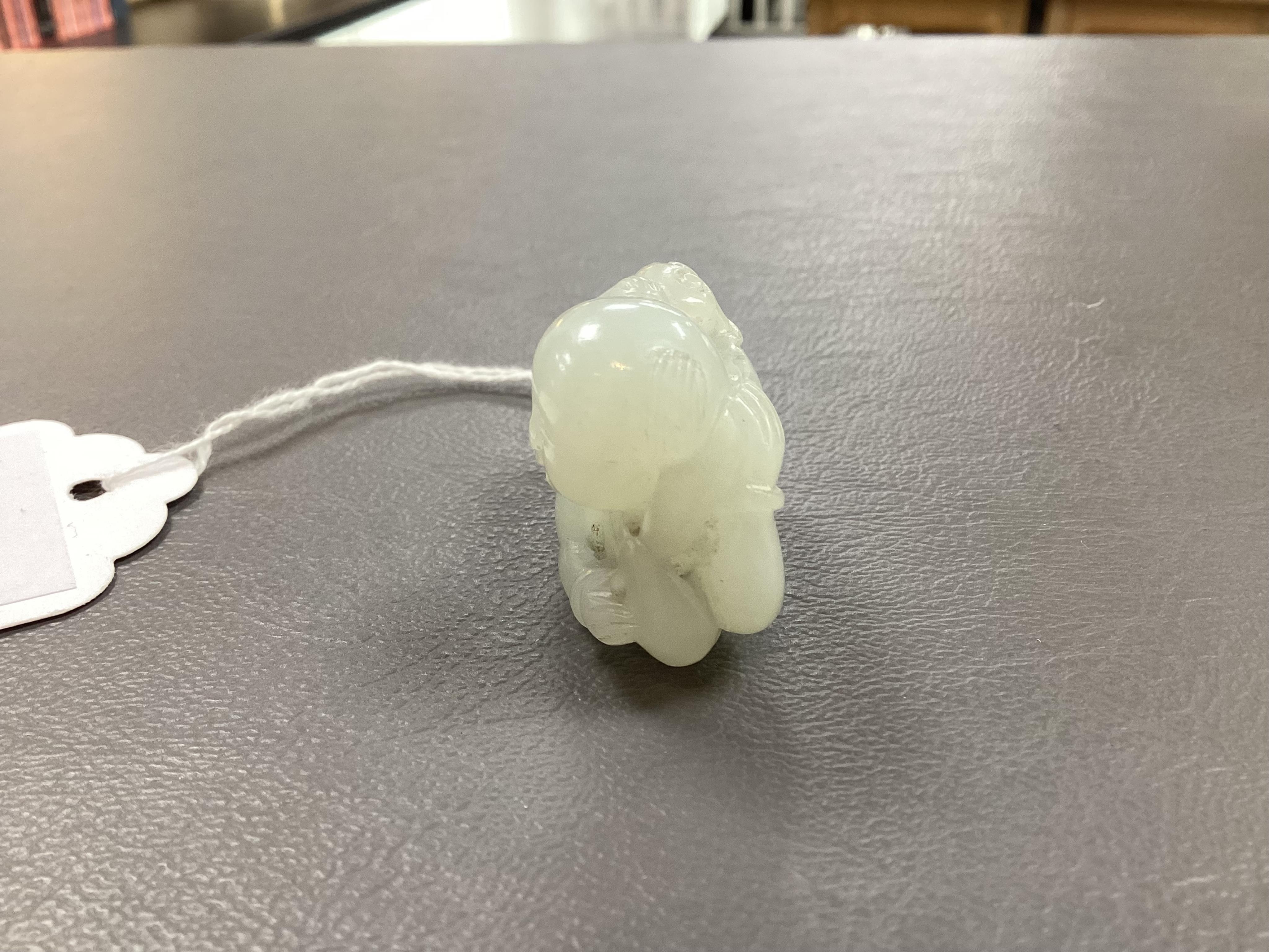 A Chinese white jade figure of a crouching boy, 19th/20th century